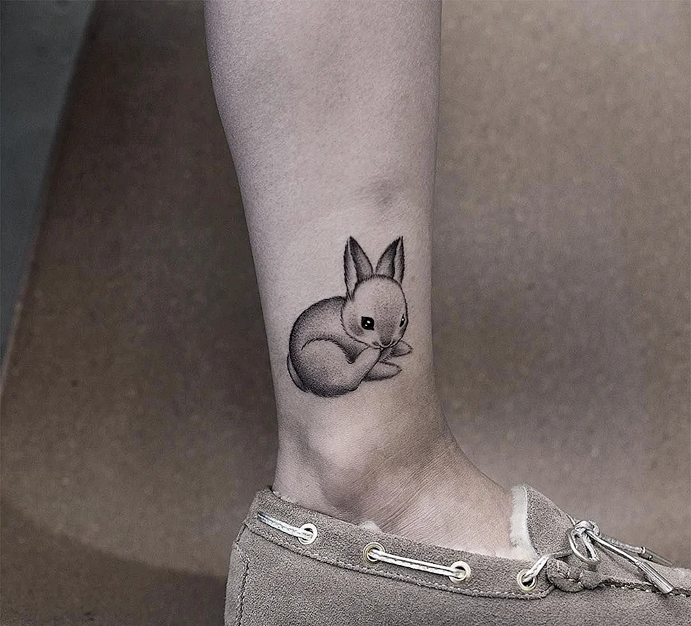 Petite girl with Playboy Bunny Tattoo on foot